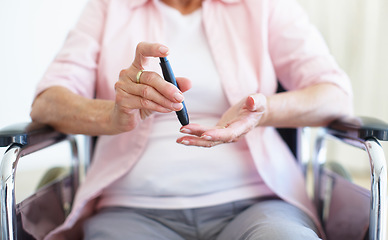 Image showing A pin-prick to the finger - DiabetesSenior Health. Cropped closeup of a senior woman checking her blood sugar levels with a prick to the finger.