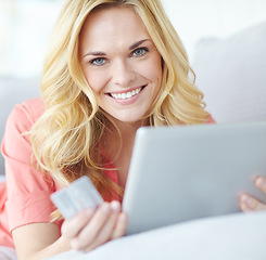 Image showing Finding everything she needs online. Portrait of a beautiful young woman using her digital tablet and credit card to shop online.