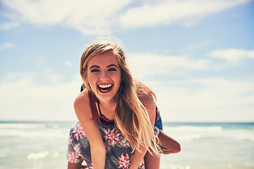 Image showing Hes always messing about. Portrait of an attractive young woman being carried by her boyfriend on the beach.