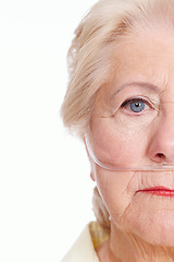 Image showing Illness takes the better part of you ... are you covered for it. Sickly senior woman wearing a nasal cannula for oxygen isolated on white - Copyspace Cropped.