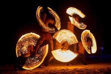 Image showing Beachside entertainment. a fire performance on a beach in Thailand.