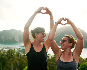Image showing We heart Thailand. two friends making a heart shape with their hands while on holiday in Thailand.