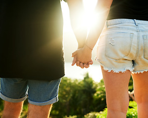 Image showing No road is too long when we are together. Rearview shot of an unrecognizable young couple standing hand in hand outside.