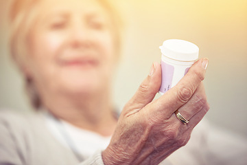 Image showing Hand, medication and woman with bottle of pills for recovery and pharmaceutical healthcare. Medical, medicine and closeup of senior female person with container with prescription tablets or vitamins.