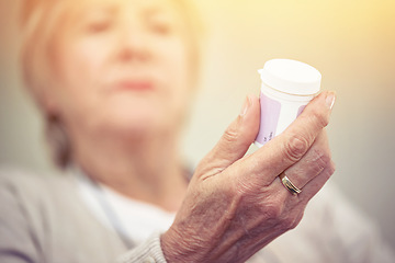 Image showing Medicine, hands and woman with bottle of pills for recovery, health and wellness. Closeup, elderly patient and reading label on medication container of prescription tablets, supplements and vitamins