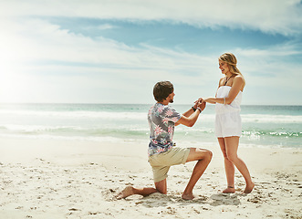 Image showing I want to spend the rest of my life with you. Full length shot of a young man proposing to his girlfriend on the beach.