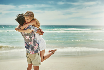 Image showing Hold me tight and never let me go. an affectionate young couple embracing on the beach.