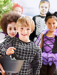 Image showing Trick-or-treating cuties. Portrait of happy little children trick-or-treating on halloween.