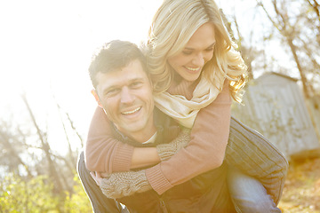 Image showing He loves to make her laugh. A happy man piggybacking his girlfriend while spending time in the woods.