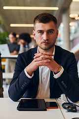 Image showing In a modern office setting, a determined director sits confidently at his desk with crossed arms, exemplifying professionalism, leadership, and unwavering resolve in the contemporary corporate world