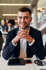 Image showing In a modern office setting, a determined director sits confidently at his desk with crossed arms, exemplifying professionalism, leadership, and unwavering resolve in the contemporary corporate world