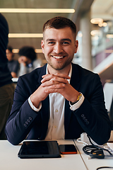 Image showing In a modern office setting, a determined director sits confidently at his desk with crossed arms, exemplifying professionalism, leadership, and unwavering resolve in the contemporary corporate world