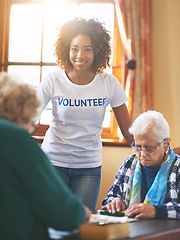 Image showing Volunteering is its own reward. a volunteer working with seniors at a retirement home.