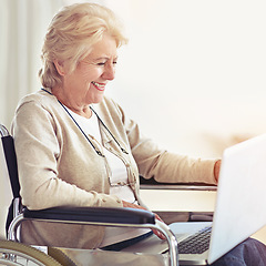 Image showing Staying in touch with her family has never been easier. a senior woman using a laptop while sitting in a wheelchair.