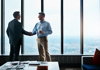 Image showing It was a pleasure doing business with you. two businessmen shaking hands in a corporate office.