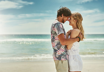 Image showing Summer, a time for love. an affectionate young couple embracing on the beach.
