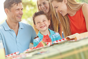 Image showing Picnic lunch in the park. Happy attractive family having a picnic in the park.