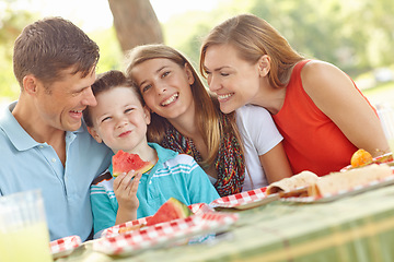 Image showing Happy family picnic lunch in the park. Happy attractive family having a picnic in the park.