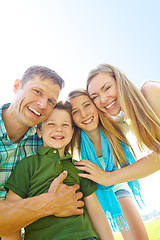 Image showing Enjoying a day of family fun outdoors. A cute young family spending time together outdoors on a summers day.