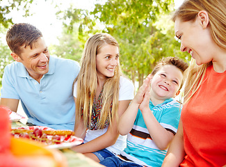 Image showing Im so hungry. A happy young family relaxing in the park and enjoying a healthy picnic.
