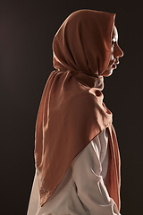 Image showing Muslim woman, profile and hijab for religion, islam or praise in faith against a dark studio background. Side view of Islamic female person or model with scarf in fashion for culture or tradition