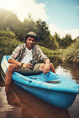 Image showing You should join me on the next adventure. Portrait of a young man going for a canoe ride on the lake.