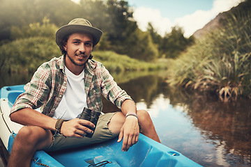 Image showing I come to the lake whenever I need an escape. Portrait of a young man going for a canoe ride on the lake.