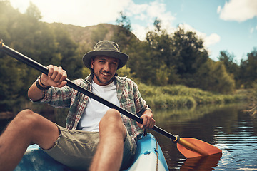 Image showing Enjoying the weekend on the water. Portrait of a young man going for a canoe ride on the lake.
