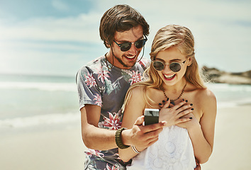 Image showing Theyre a match made in heaven. a young man proposing to his girlfriend on the beach.