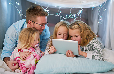 Image showing Hes there to ensure safe online browsing. a father and his daughters using a digital tablet before bedtime.