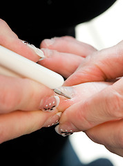 Image showing Foot therapist working on a pair of feet 