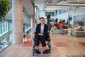 Image showing In a modern office, a young businesswoman in a wheelchair is surrounded by her supportive colleagues, embodying the spirit of inclusivity and diversity in the workplace