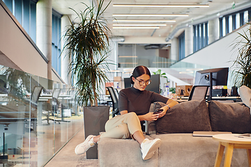 Image showing In a modern startup office, a businesswoman collaboratively tackles various business problems and challenges, surrounded by their engaged colleagues, fostering innovation and productivity