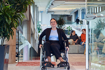 Image showing In a modern office, a young businesswoman in a wheelchair is surrounded by her supportive colleagues, embodying the spirit of inclusivity and diversity in the workplace