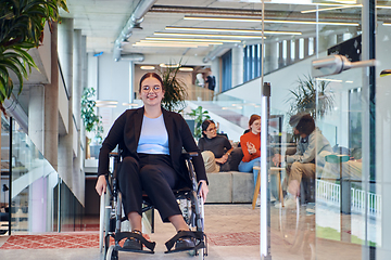 Image showing In a modern office, a young businesswoman in a wheelchair is surrounded by her supportive colleagues, embodying the spirit of inclusivity and diversity in the workplace
