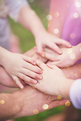 Image showing Family fun. Closeup shot of a family with their hands in a huddle outside.