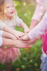 Image showing Fun and games with family. Closeup shot of a family with their hands in a huddle outside.