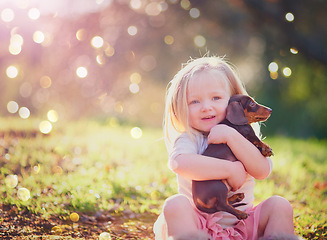 Image showing Have you met my cute little pup. Portrait of an adorable little girl sitting with her puppy outside.