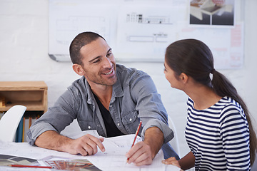 Image showing Hes very happy with her progress. a man and young woman discussing blueprints.