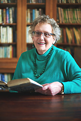 Image showing Keeping my mind sharp and enjoying every page of it. Portrait of a smiling senior woman sitting at a table reading.