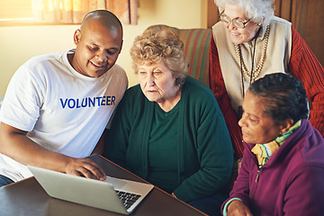 Image showing And its as easy as hitting Enter. a volunteer showing a group of senior women how to use a laptop.