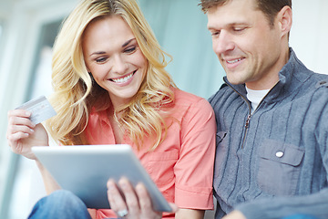 Image showing Should we take it. a happy mature couple shopping online using a digital tablet while relaxing together at home.