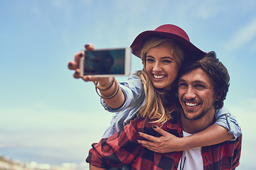 Image showing The perfect place for a selfie. an affectionate young couple taking selfies while hiking in the mountains.