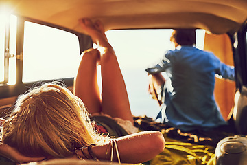 Image showing Theyll never stop exploring. Rearview shot of a young couple relaxing inside their car during a roadtrip.