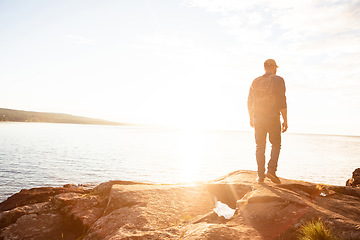 Image showing Hiking is the perfect activity for you. a man wearing his backpack while out for a hike on a coastal trail.