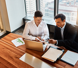 Image showing Every piece of information is important. two businessmen having a discussion while sitting by a laptop.