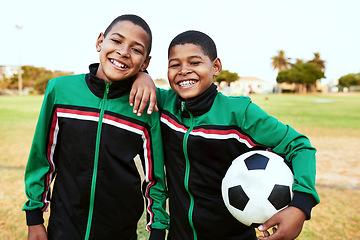 Image showing When you need a friend, you can always count on your teammates. Portrait of two young boys playing soccer on a sports field.