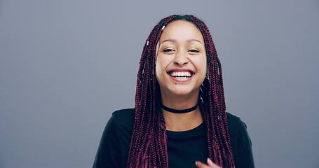 Image showing Face, gen z or happy woman in studio laughing at joke or crazy comedy isolated on gray background. Funny girl, model or cool female person with freedom, silly smile or joy to relax alone with humor