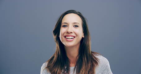 Image showing Face, happy or woman laughing at joke or crazy comedy in studio isolated on gray background. Funny, excited model or silly female person with freedom, goofy smile or joy to relax alone with humor