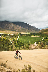 Image showing Instead of getting lost, its where you find yourself. a young man cycling along a trail.